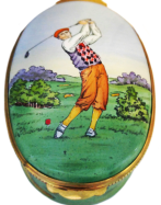 Golfer (Crummles) 3" Oval (large) Inside Lid: Painting of a golf club hitting a ball on a tee. Sides are decorated with a painting of a golf course.