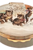 Kittens at Door (02/5810) 2.12" oval. Base is an olive greenish color. Inside Lid: drawing of a bow/ribbon. Smithsonian word and symbol on base.